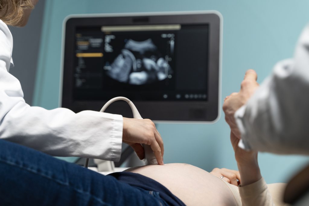 gynecologist performing ultrasound consultation